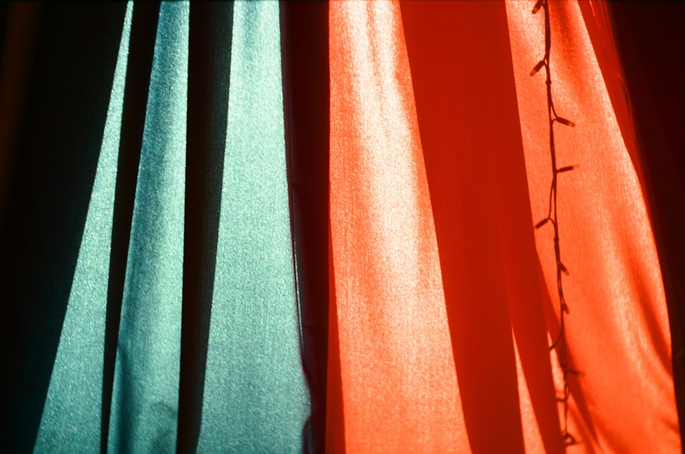 a close up of a curtain with a plant on it