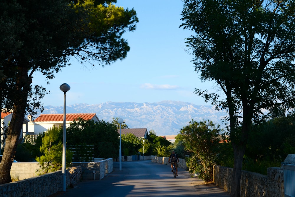 a person riding a bike down a street