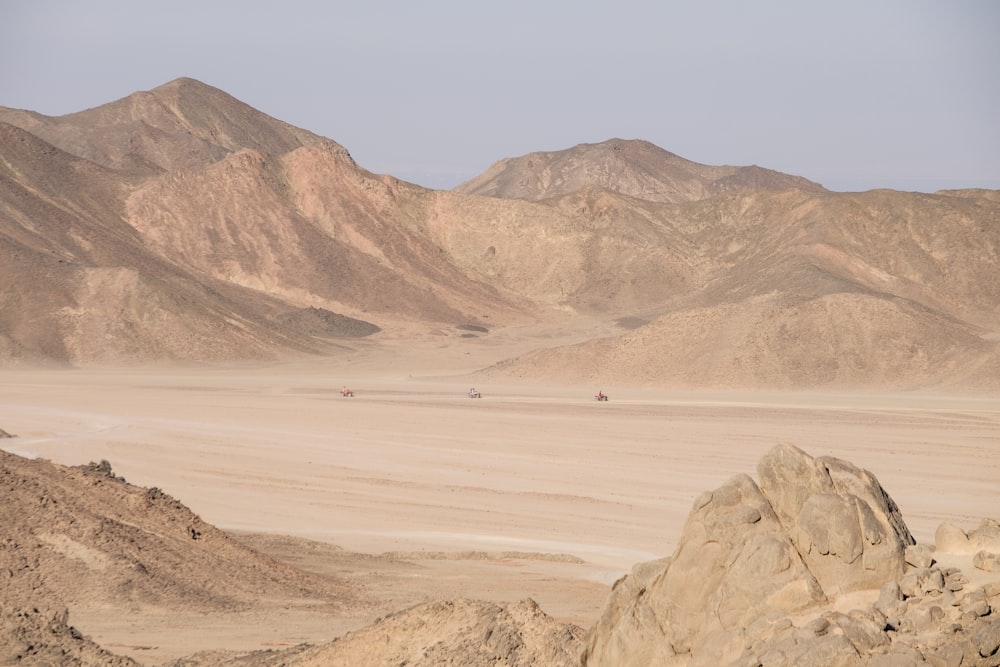 a desert landscape with mountains in the background