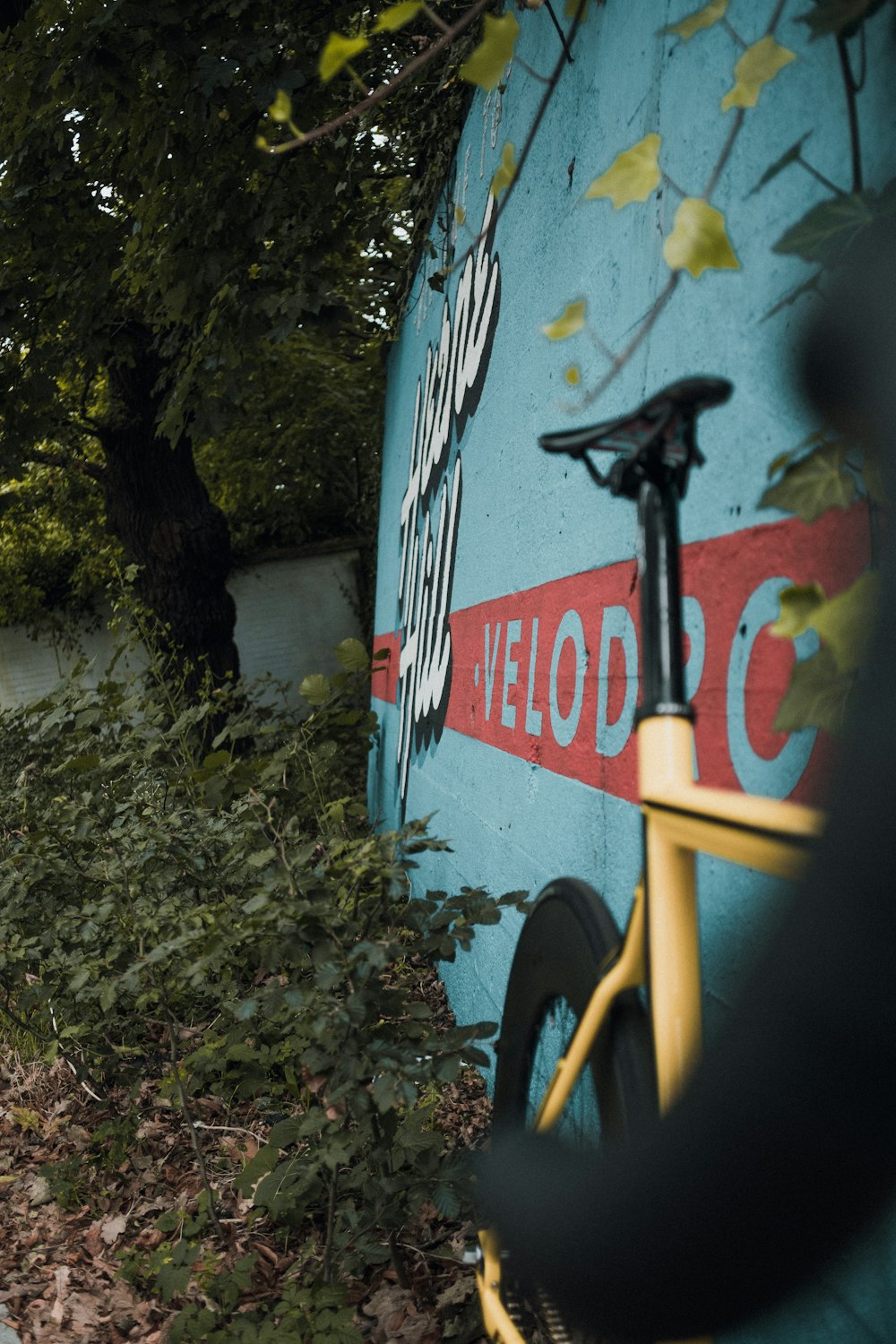 a bicycle leaning against a wall with a sign on it