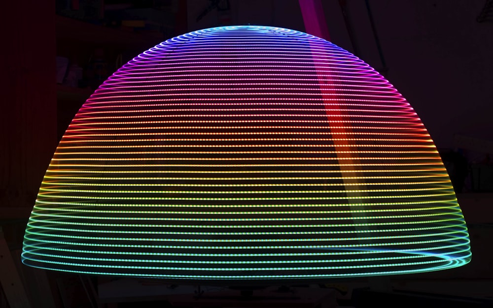 a multicolored light fixture in a dark room