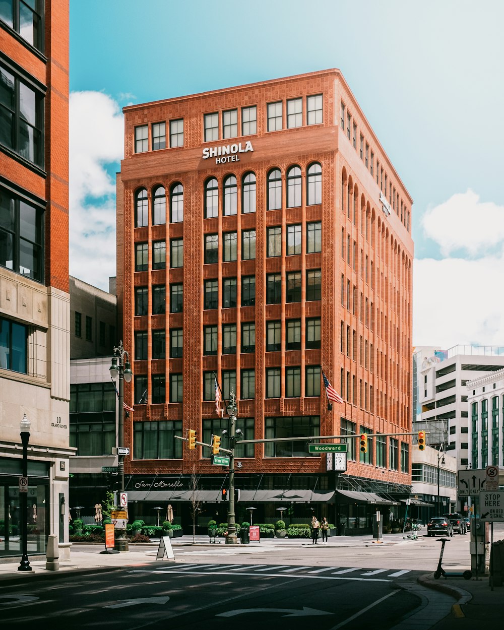 a tall red brick building sitting on the corner of a street