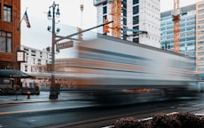 a train traveling down a city street next to tall buildings
