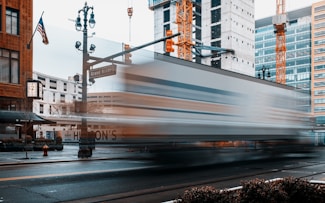 a train traveling down a city street next to tall buildings