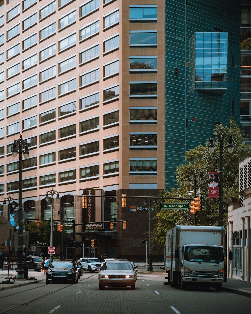 a city street filled with traffic next to tall buildings