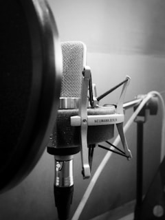 A close-up of a professional microphone in a recording studio.