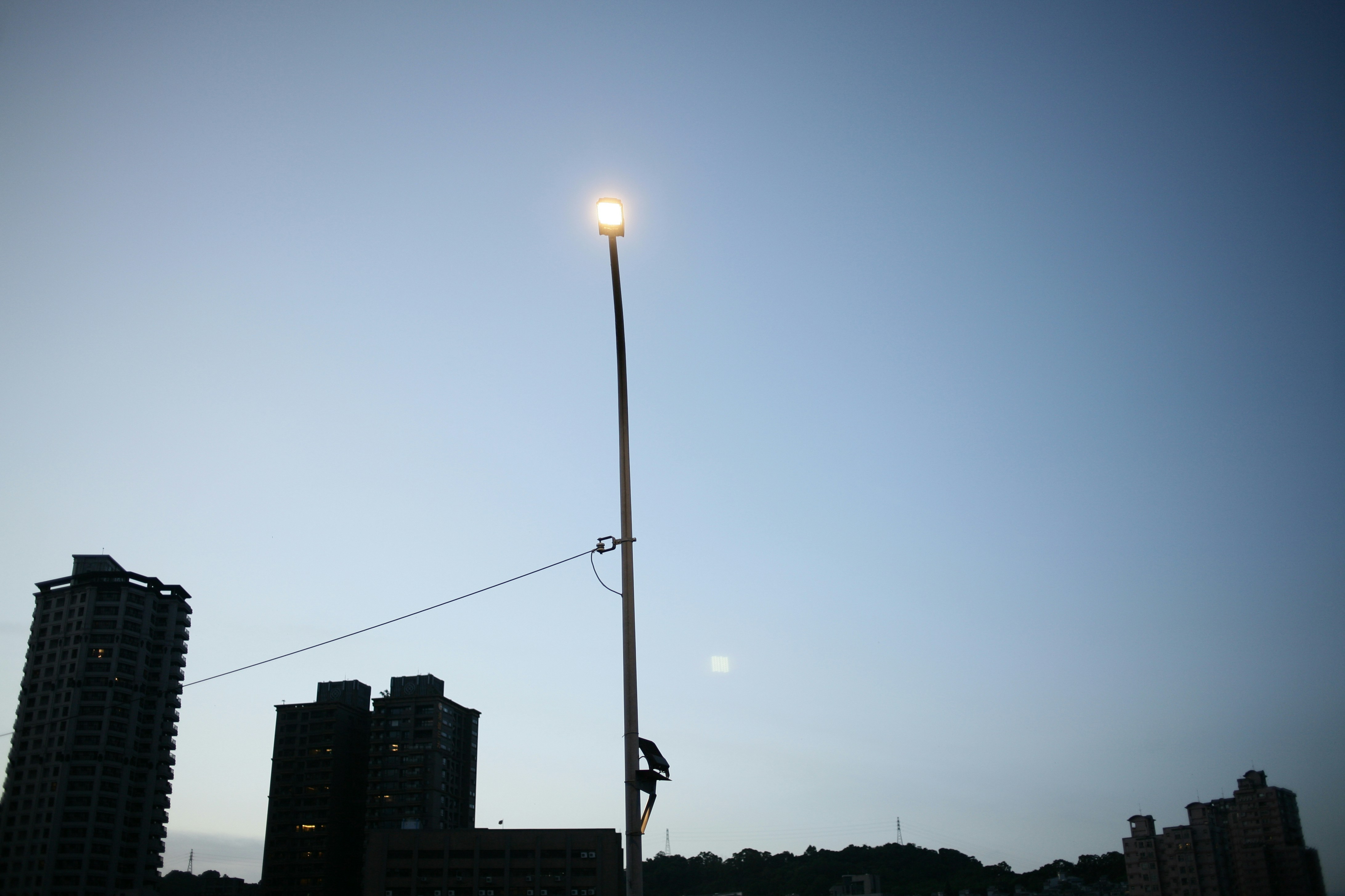 a street light on a pole in the middle of a city
