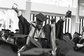 A successful graduate celebrating with a diploma in hand.