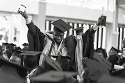 Graduates celebrating their achievement with proud smiles and diplomas
