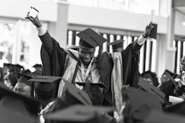A successful graduate celebrating with a diploma in hand.