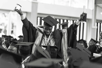 Graduates celebrating their achievement with proud smiles and diplomas