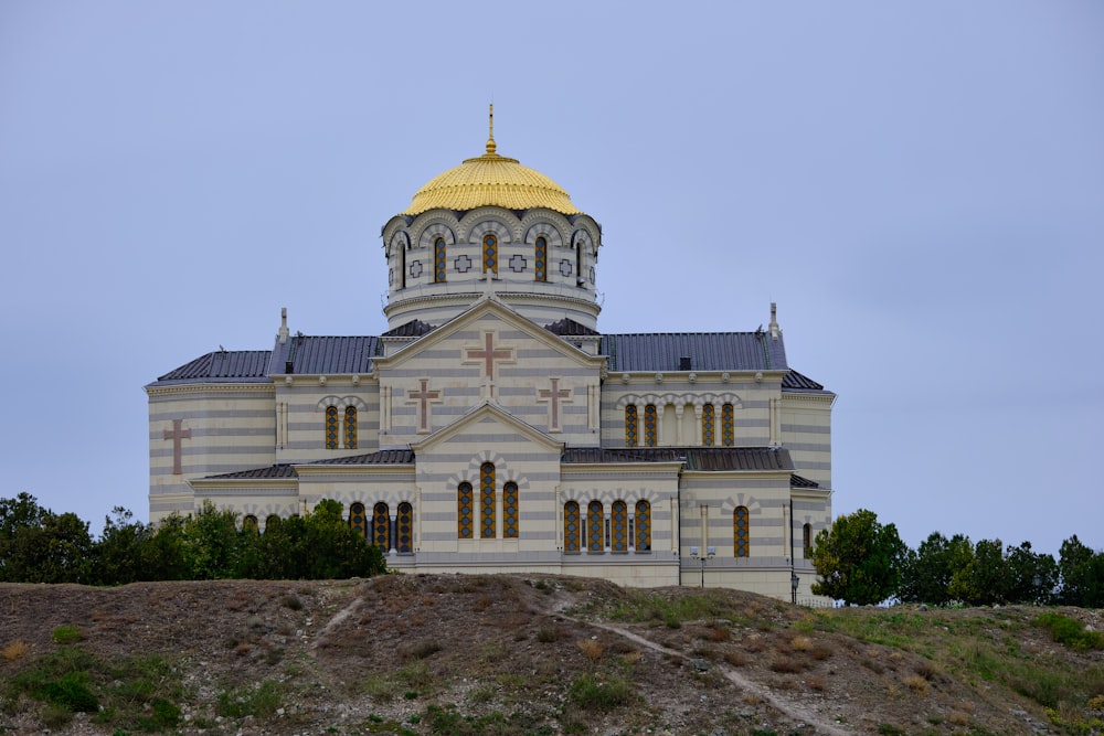 a large white building with a yellow dome