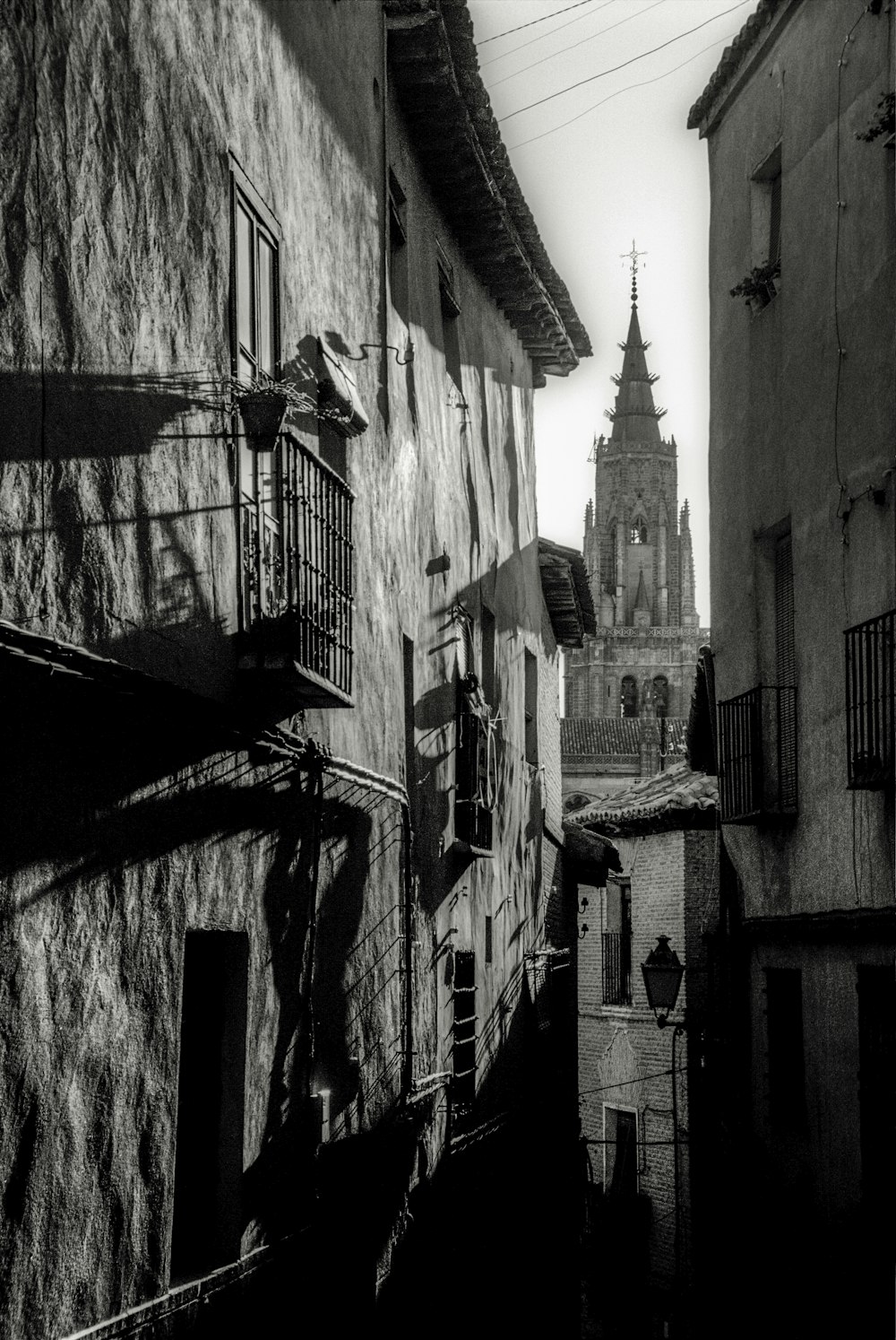 a black and white photo of a steeple and buildings
