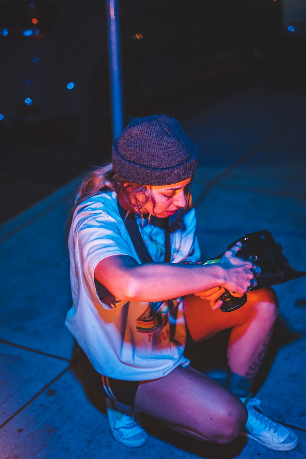 a person sitting on the ground with a cell phone