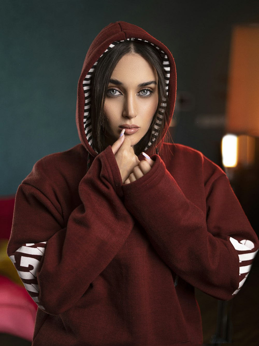 a woman in a red hoodie posing for a picture