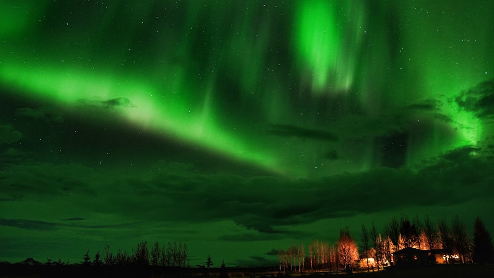 a green and black sky filled with lots of lights