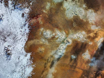 Close-up of geothermal pipes embedded in the earth, illustrating sustainable energy extraction.