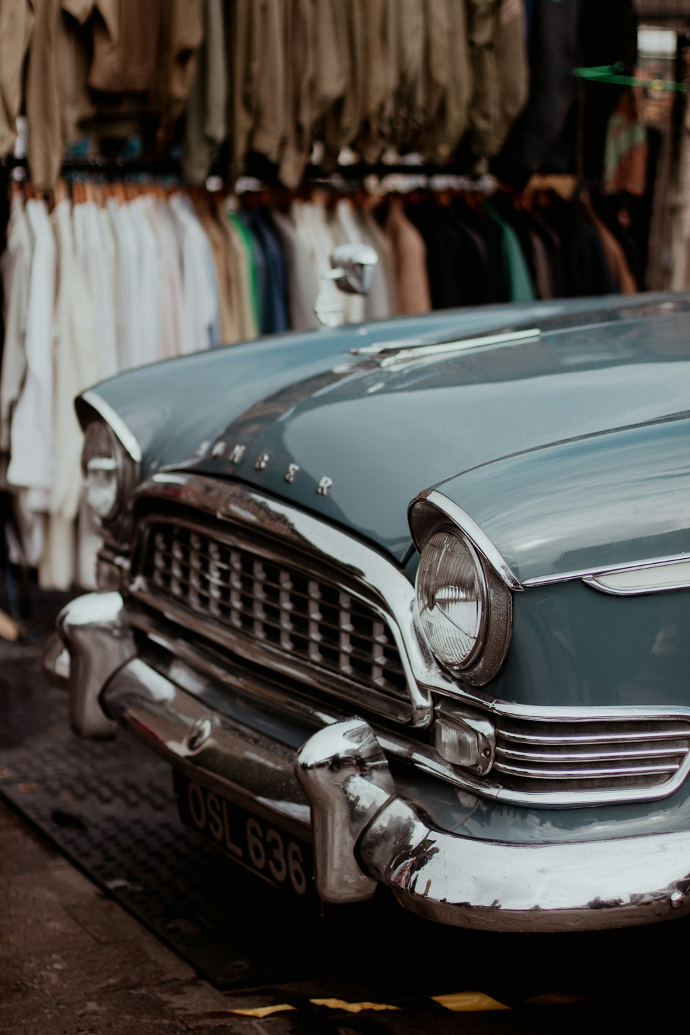 an old car is parked on the side of the road