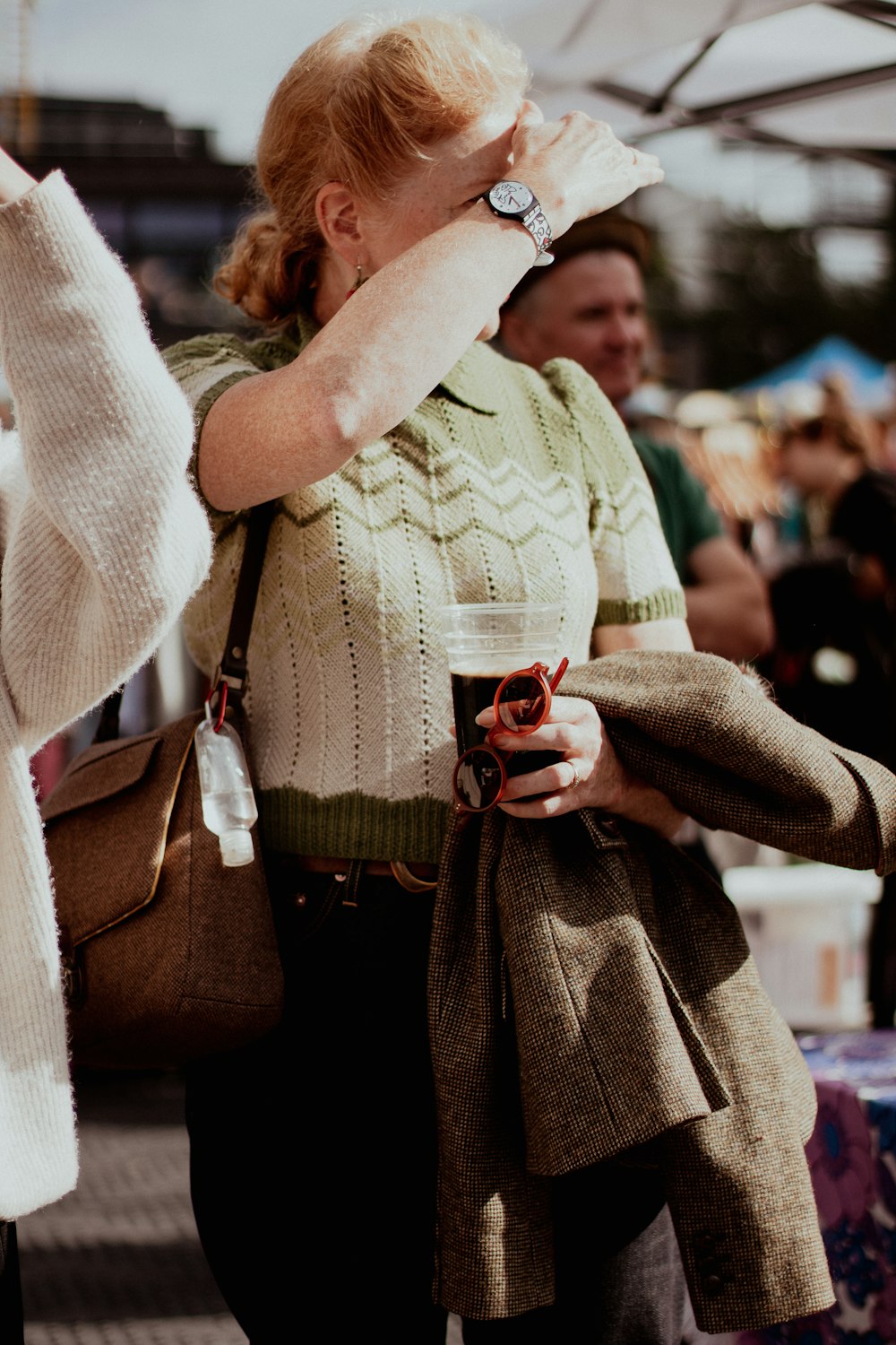 a woman holding a cup of coffee in her hand