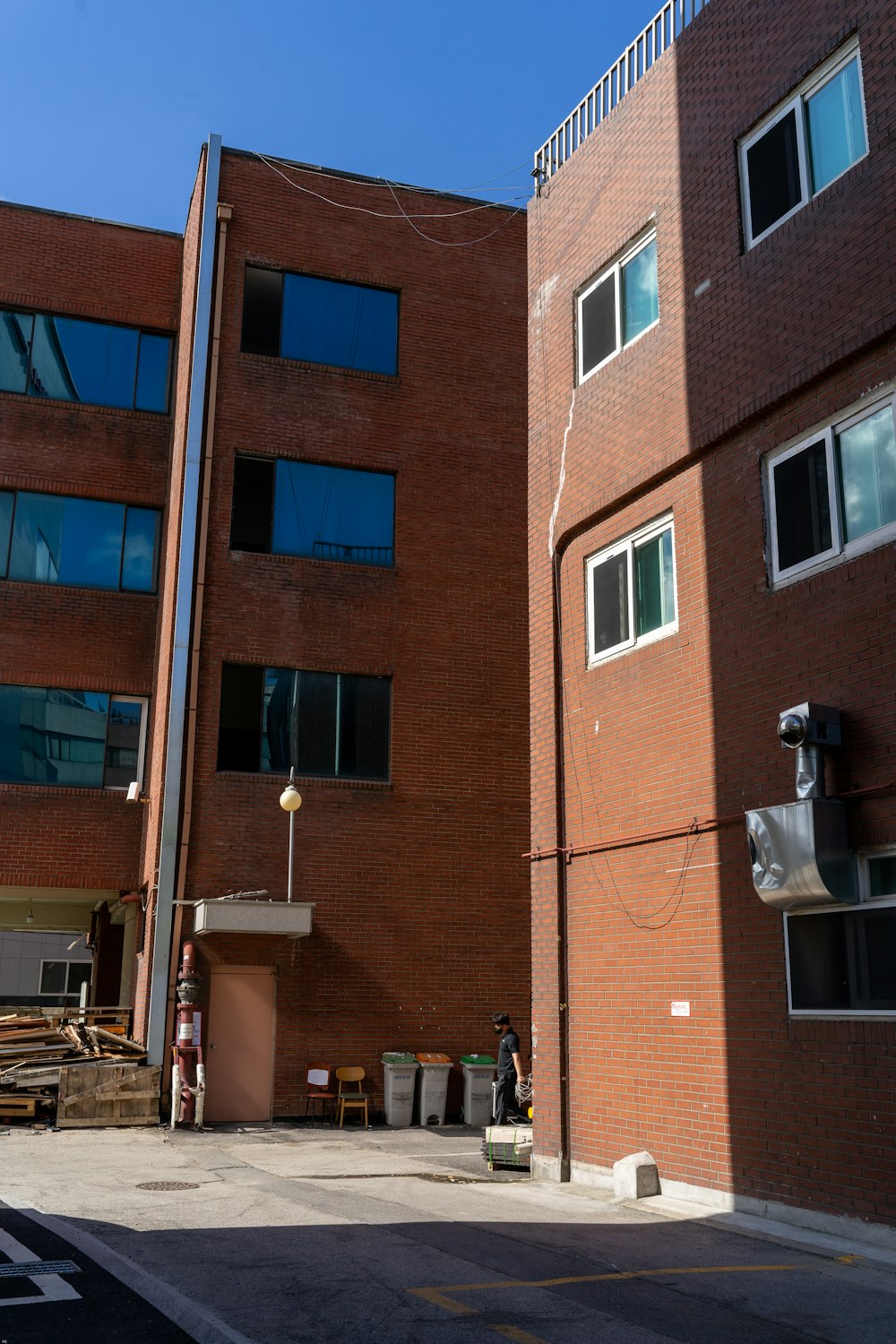 a tall brick building sitting next to a parking lot