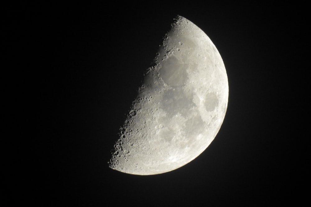 a close up of a half moon in the dark sky