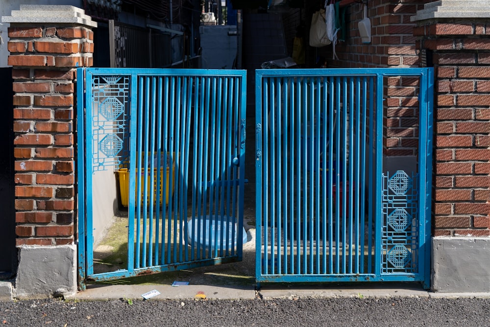 a couple of blue gates that are on the side of a building