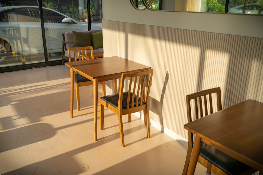 a wooden table and chairs in a room