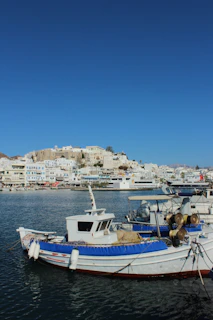 Charming fisherman's house with white walls and blue shutters nestled by the sea.