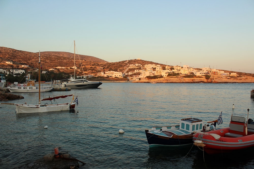 a group of boats floating on top of a body of water