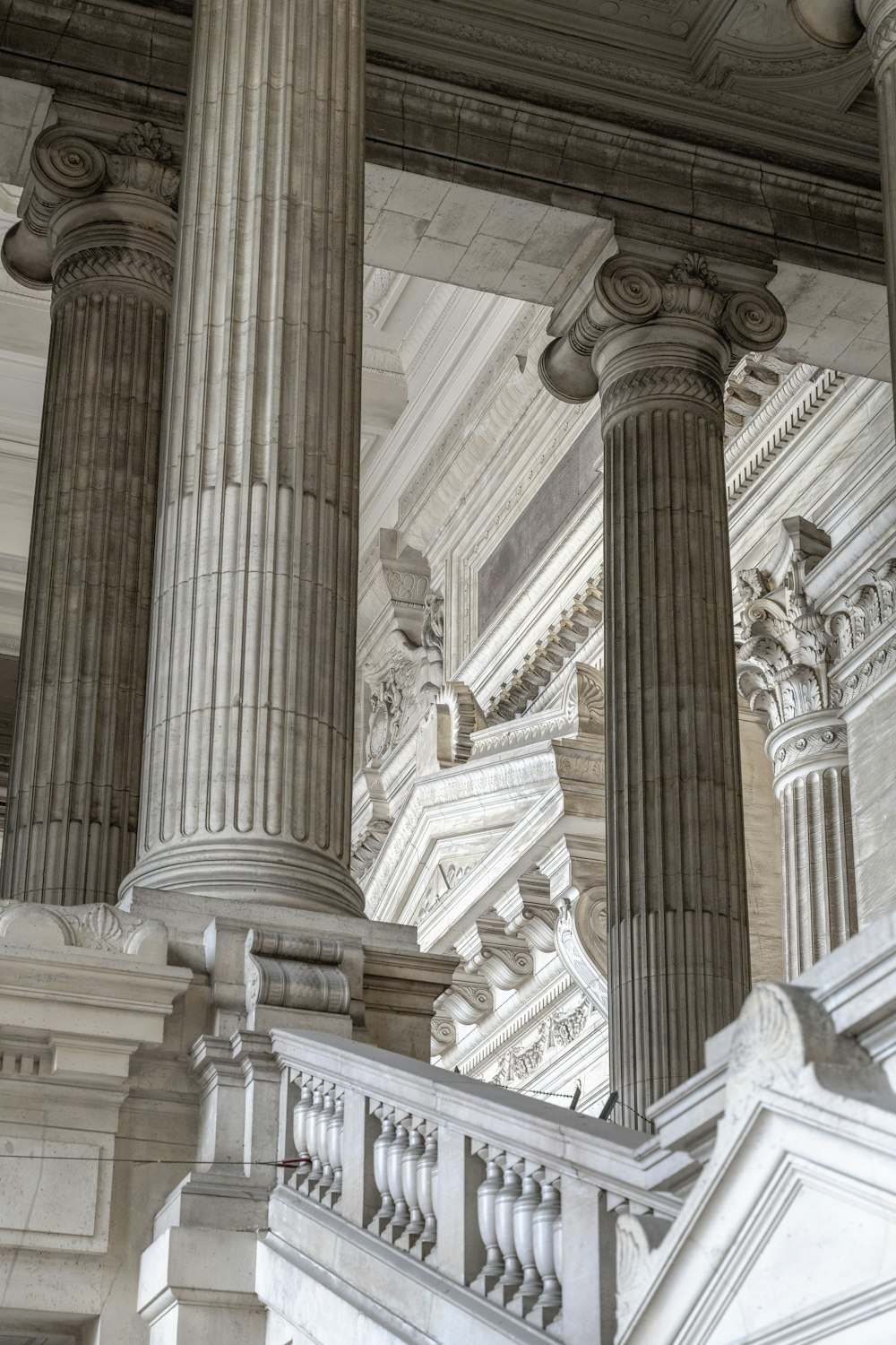 a building with columns and a clock on the side of it