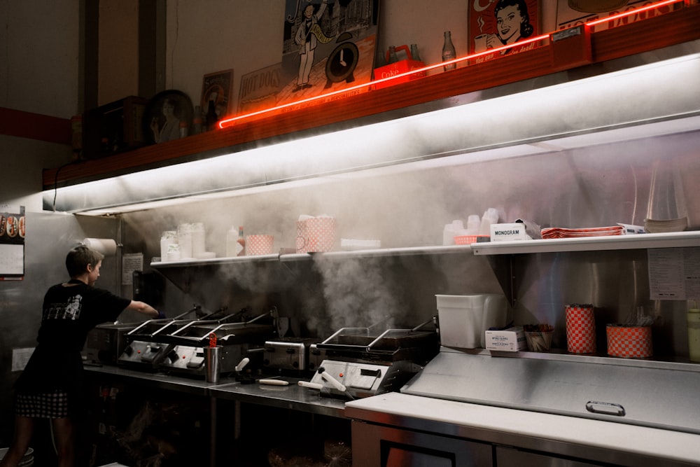 a person standing in a kitchen preparing food