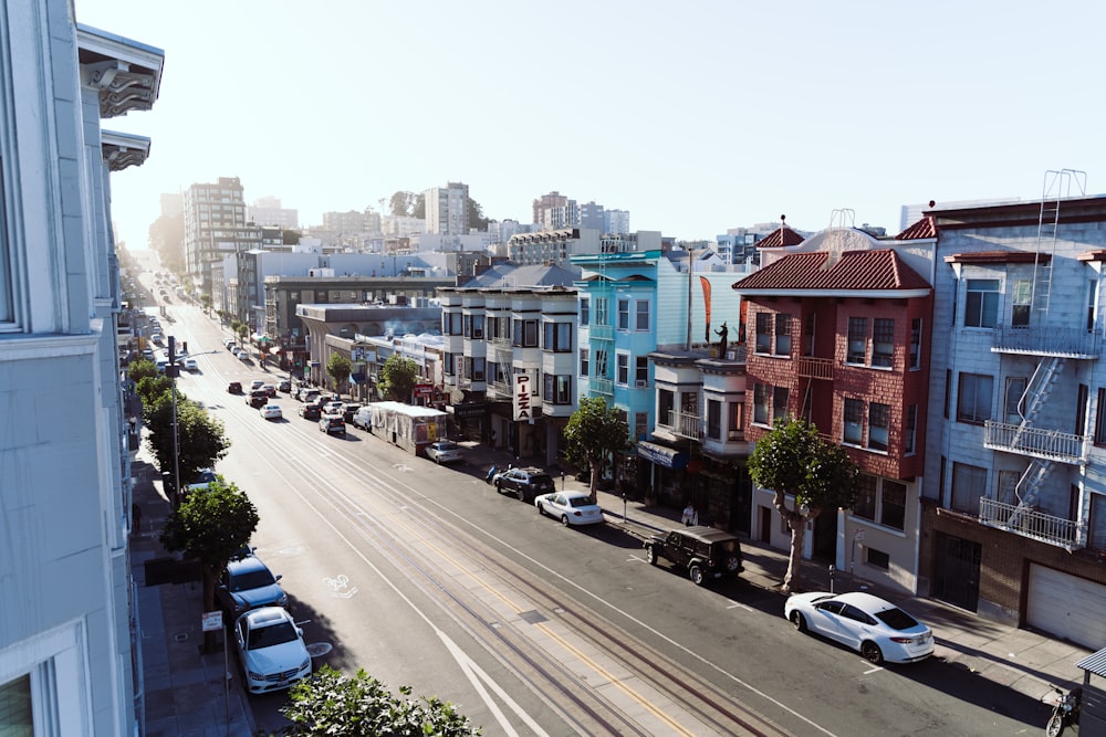 a city street filled with lots of traffic next to tall buildings