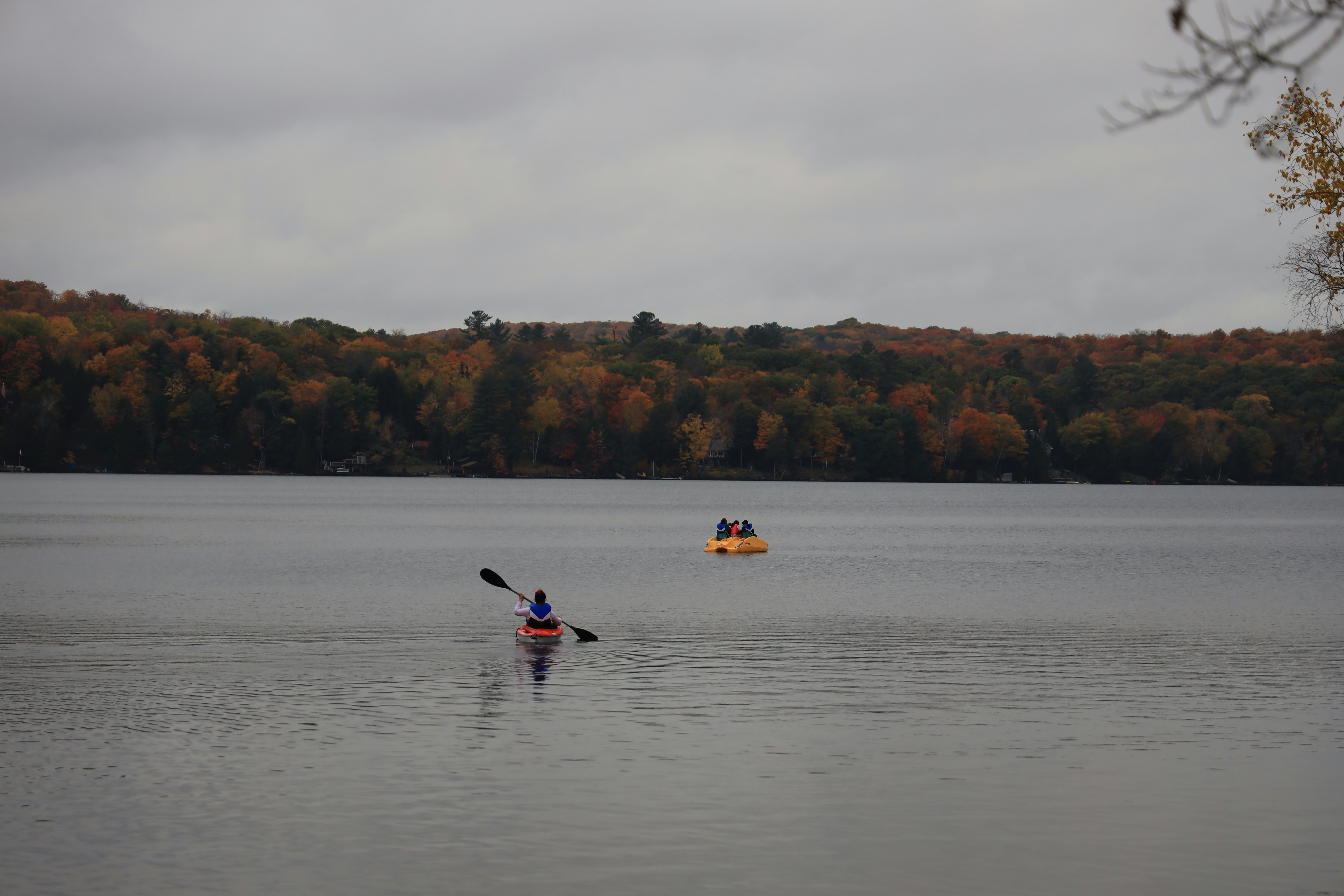 a person in a kayak paddling on a lake