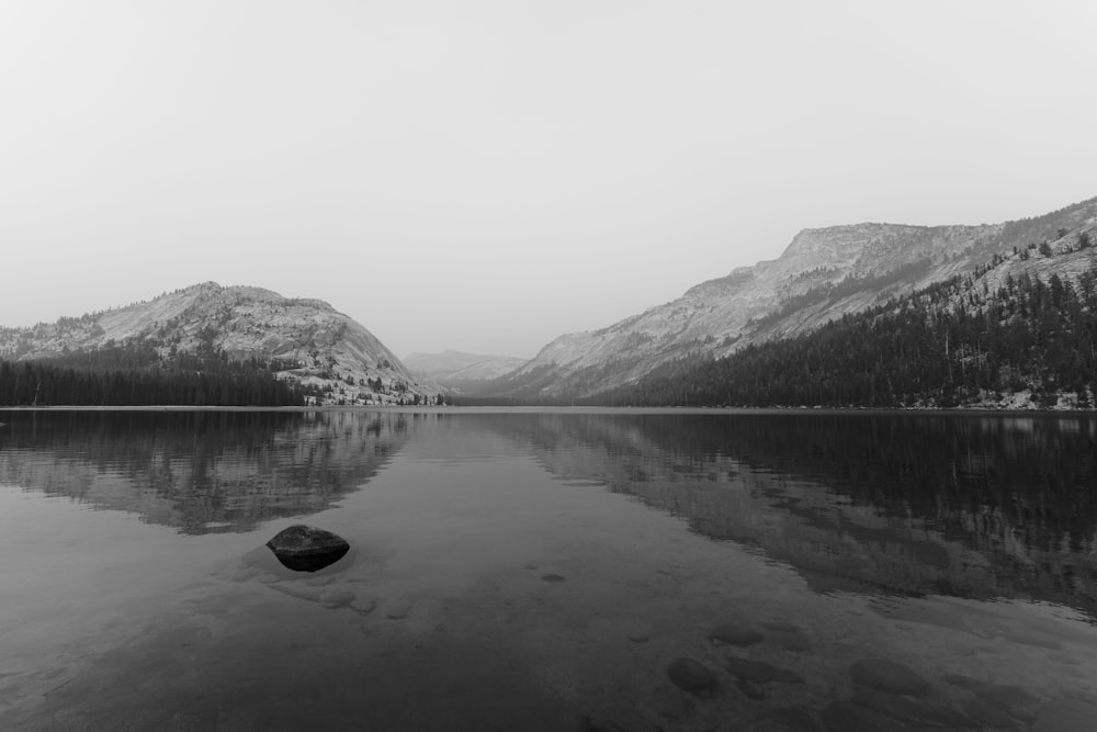 a black and white photo of a mountain lake