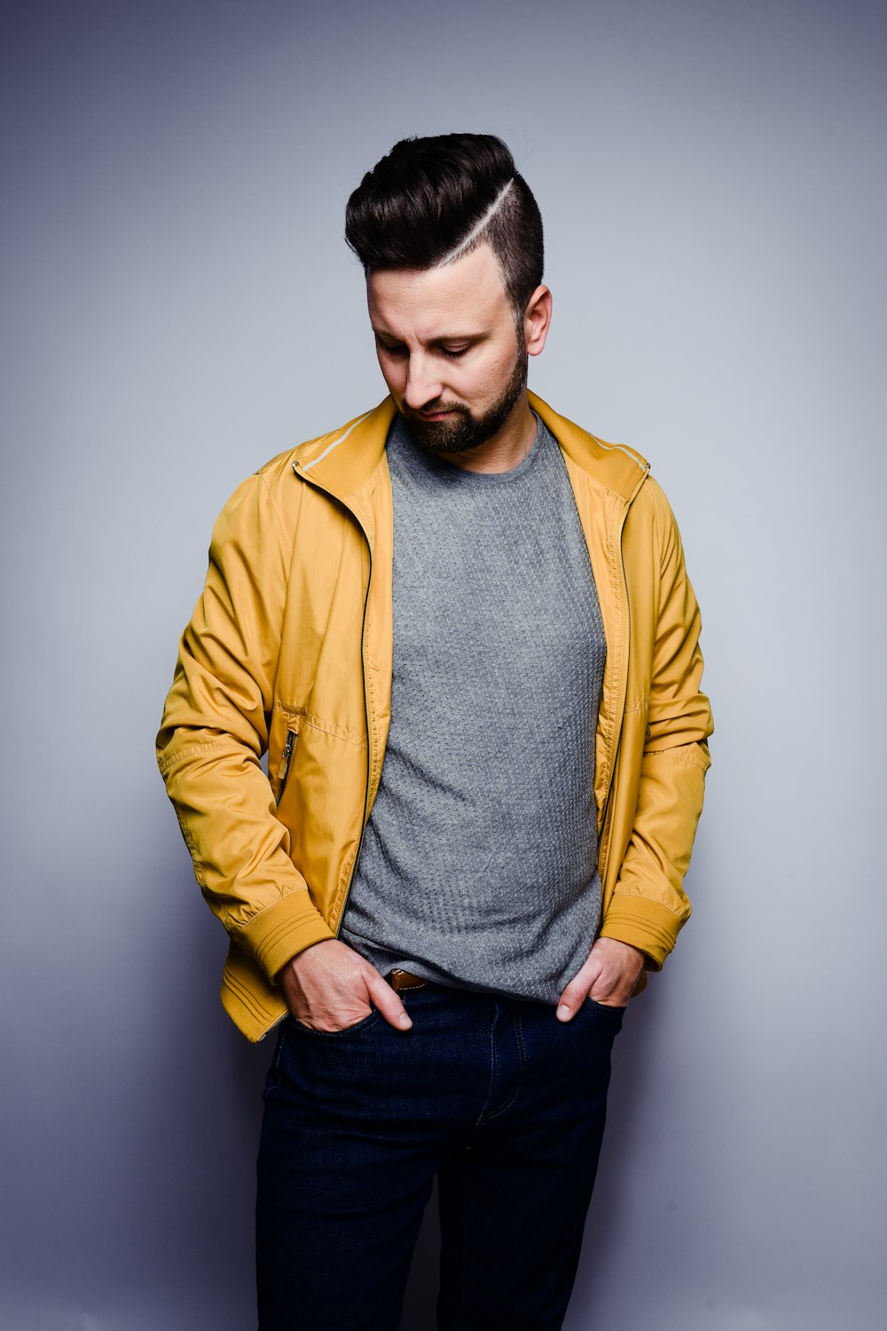 a man in a yellow jacket is posing for a picture