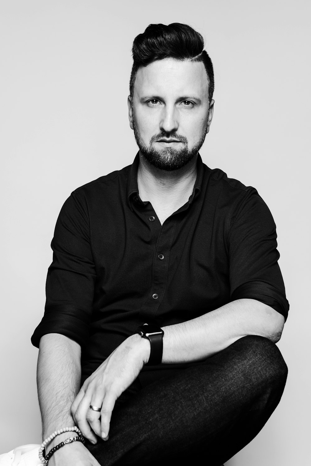 a black and white photo of a man with a beard