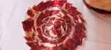 A selection of premium Iberian ham displayed on a wooden board.