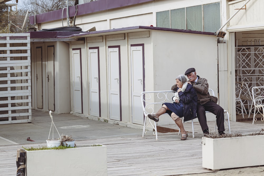 a man and a woman sitting on a bench