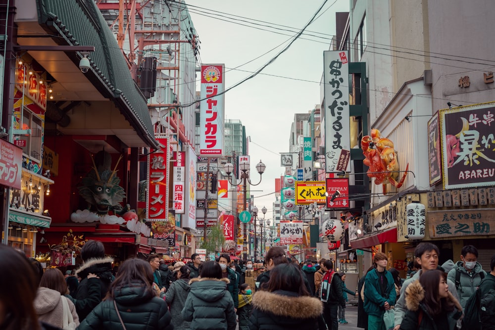 a crowded city street filled with lots of people