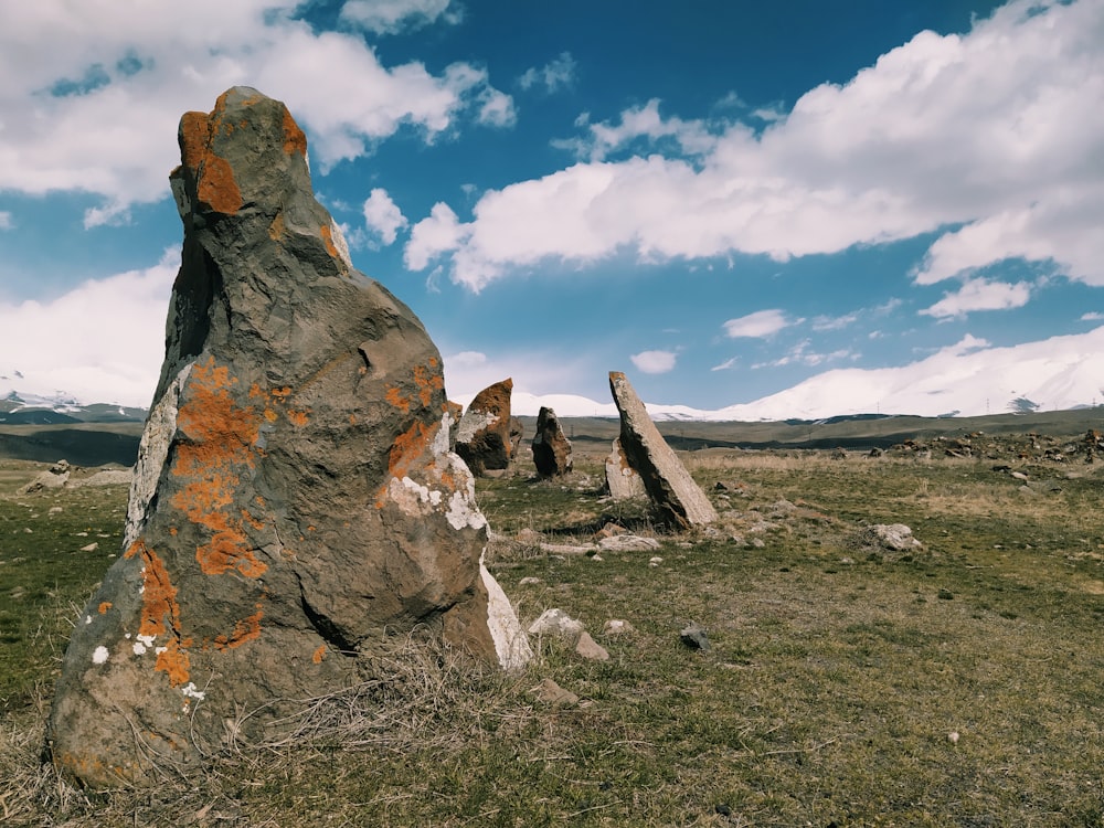 a large rock in the middle of a field