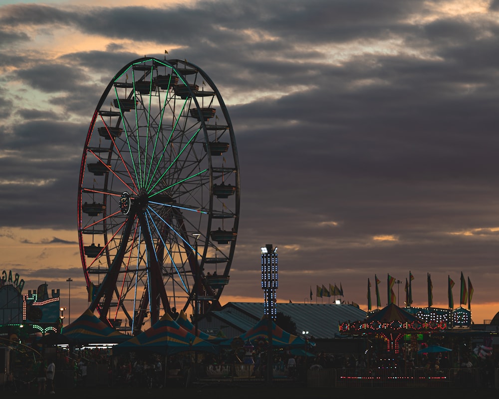 a ferris wheel sitting in front of a cloudy sky