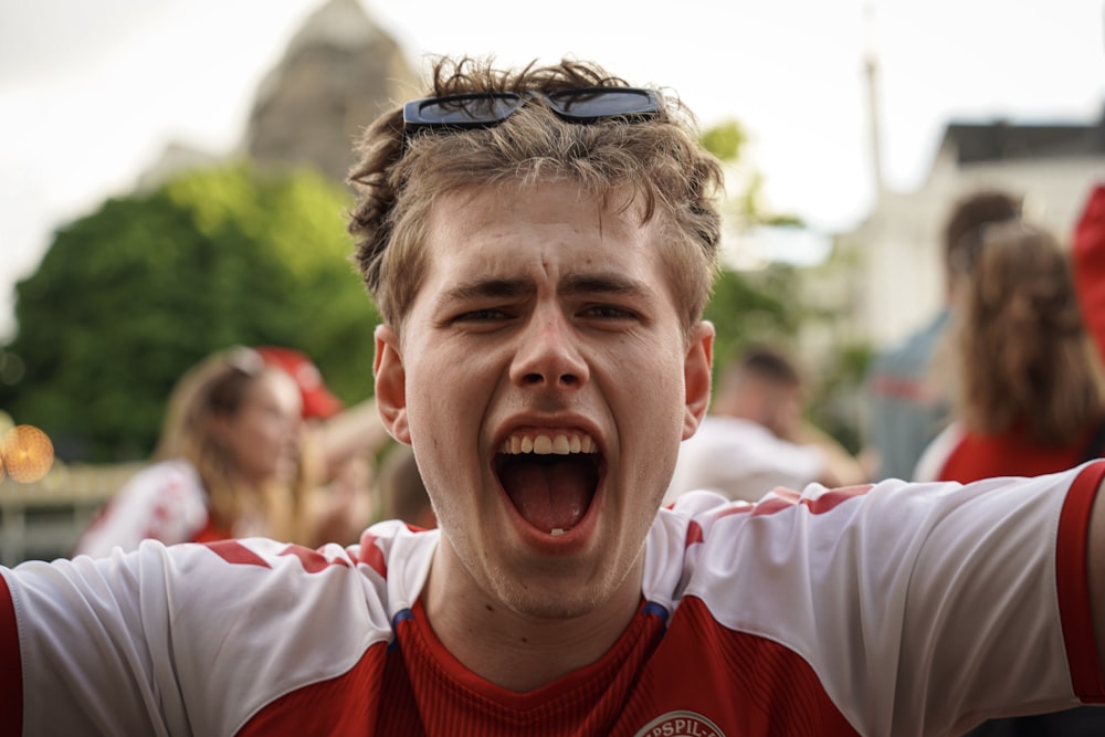 a man with his mouth open and sunglasses on