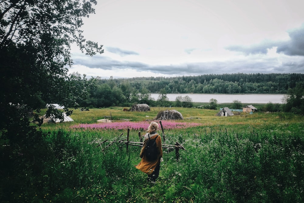 a woman standing in a field of flowers