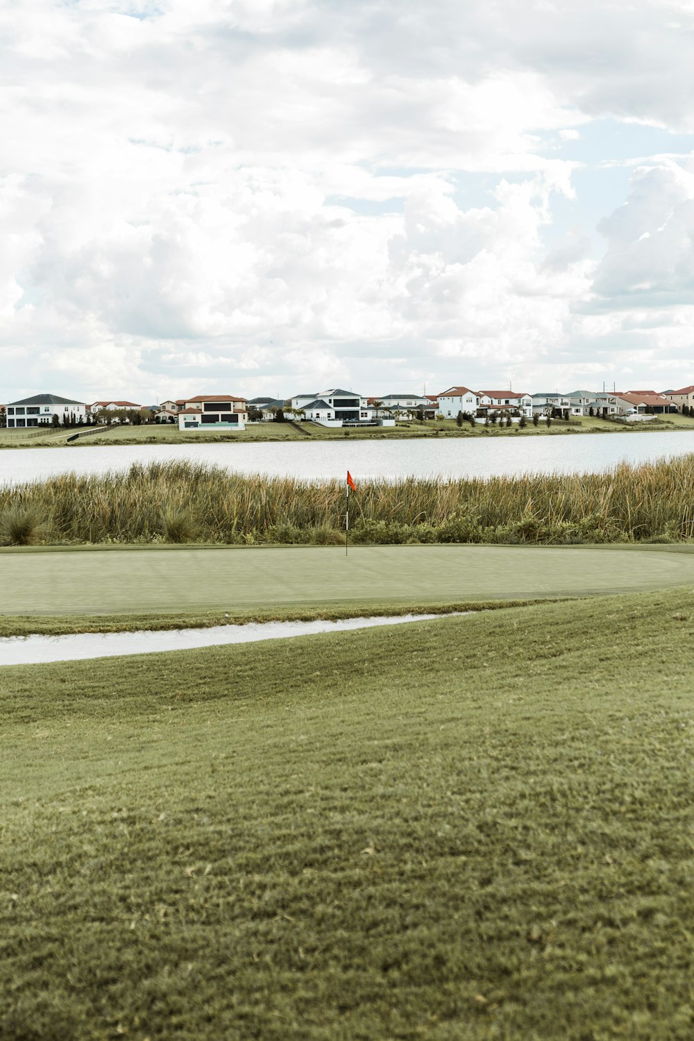 a man is flying a kite on a golf course