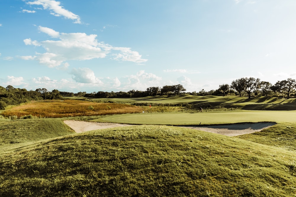 a view of a golf course from the top of a hill