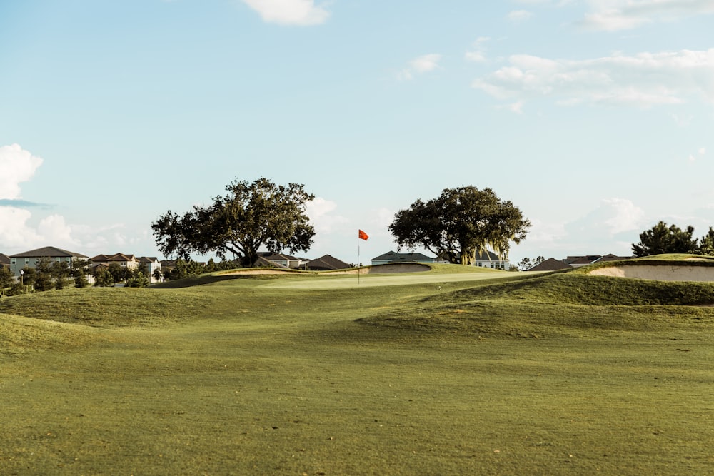 a golf course with a red ball in the distance