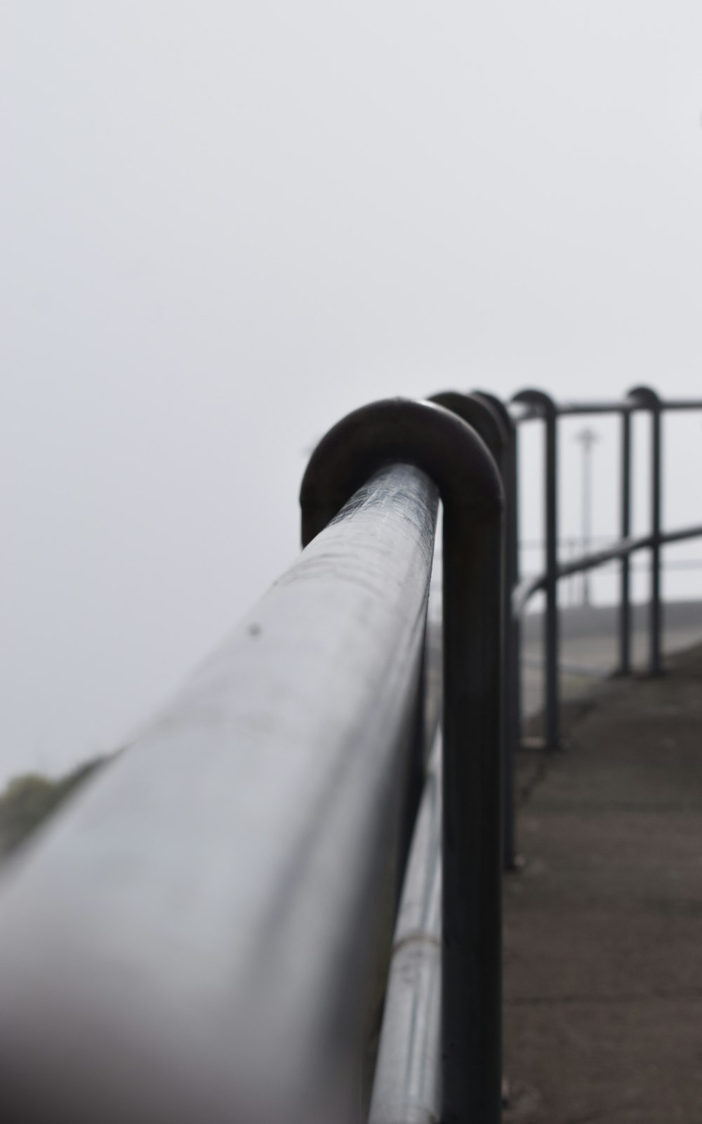 a person standing on a bridge with a cell phone