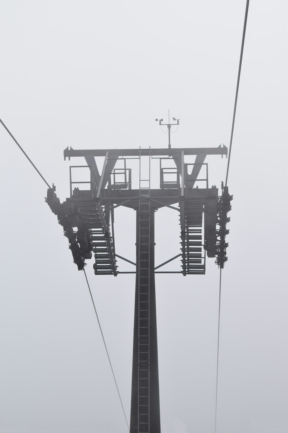 a ski lift in the fog on a foggy day