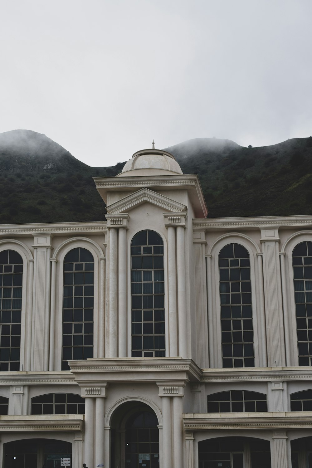 a large white building with a clock on the top of it