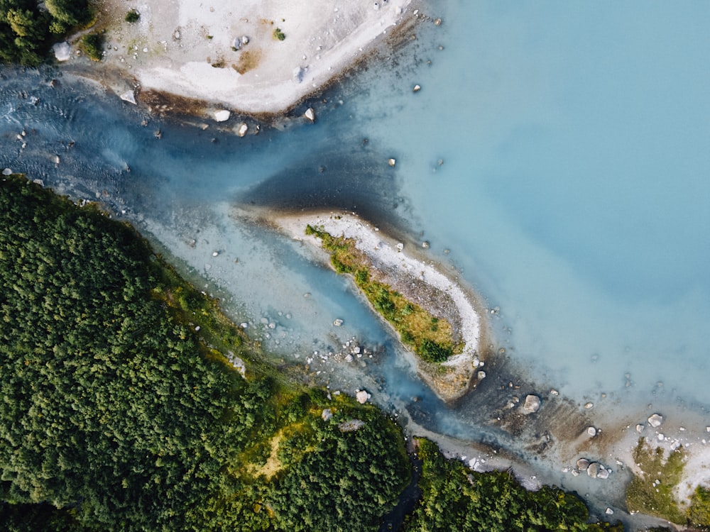 an aerial view of a body of water surrounded by trees